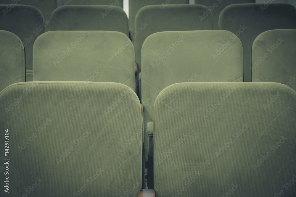 Obraz premium Conference hall or cinema interior with rows of green chairs