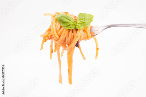 Spaghetti bolognese on a fork on a white background
