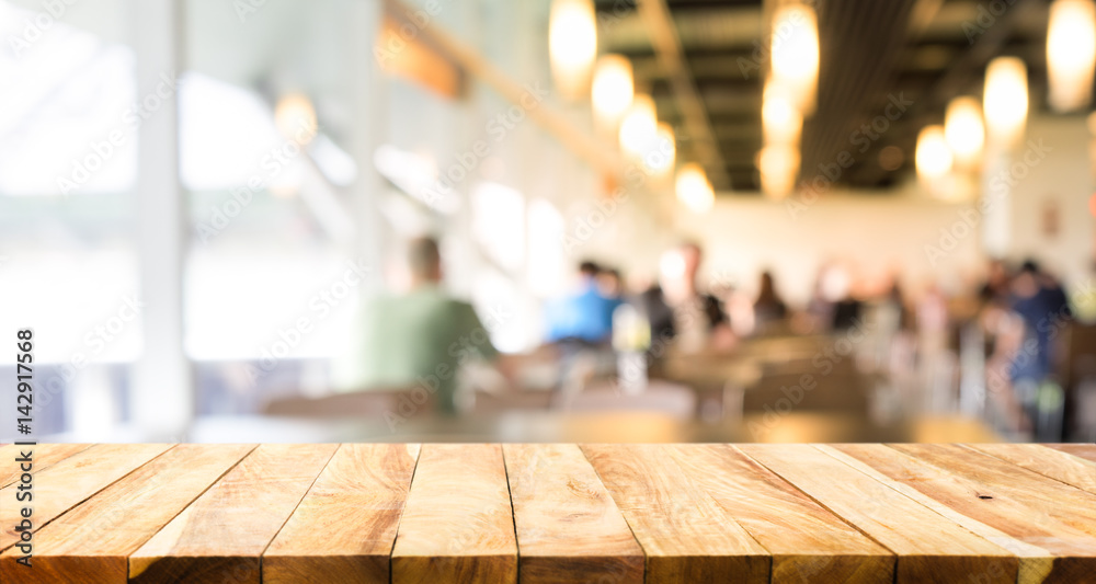 Empty of wood table top on blurred of people in coffee shop (cafe restaurant ) background.For create product display key visual layout Empty of wood table top on blurred of people in coffee shop (cafe restaurant ) background.For create product display key visual layout