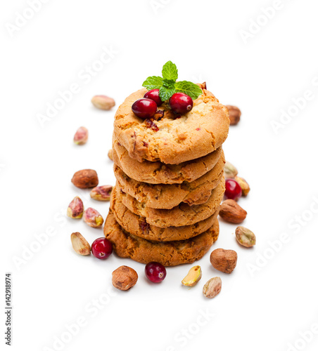 Stack of oat cookies with cranberry and pistachio isolated on white