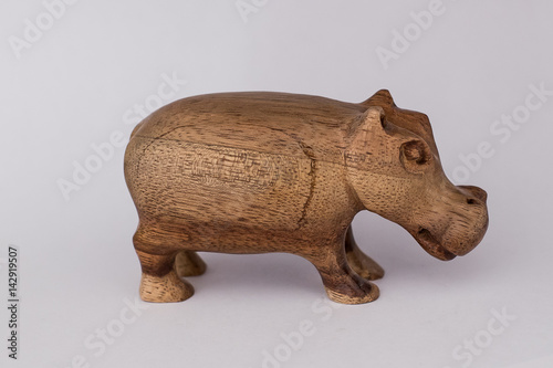Wooden figurine on a white background, hippo