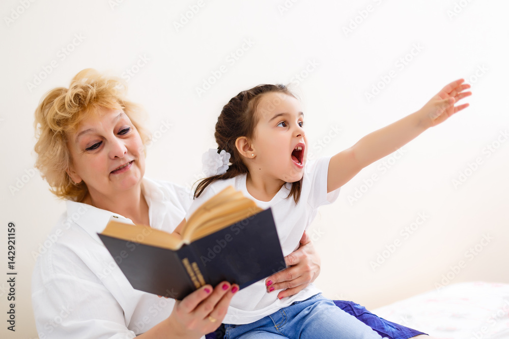Asian grandmother and granddaughter looking at laptop Asian grandmother and granddaughter looking at laptop