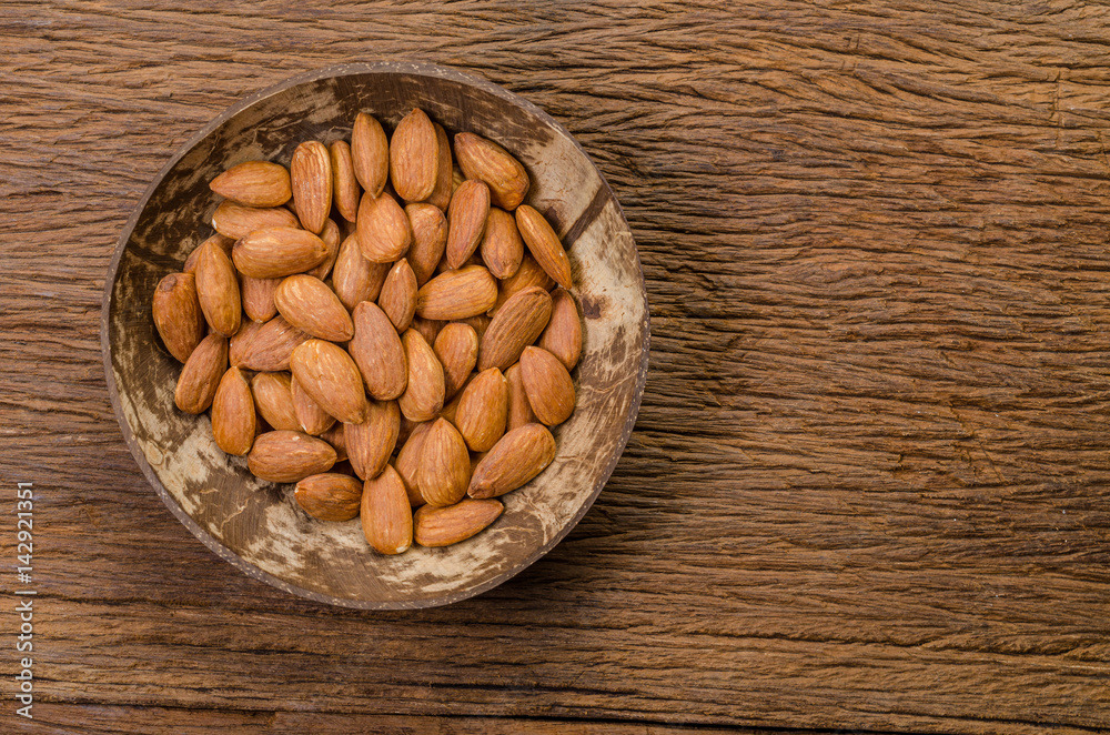 almond in wooden bowl on wooden board almond in wooden bowl on wooden board