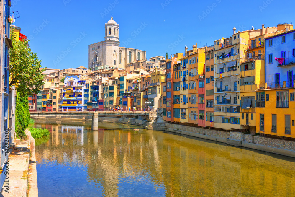 Colorful yellow and orange houses in historical jewish quarter of Girona, Catalonia, Spain. Saint Mary Cathedral.