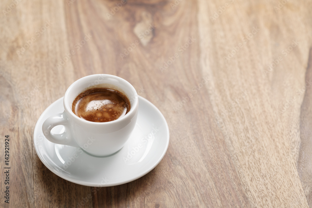 cup of fresh espresso on wood table with copy space, shallow focus cup of fresh espresso on wood table with copy space, shallow focus