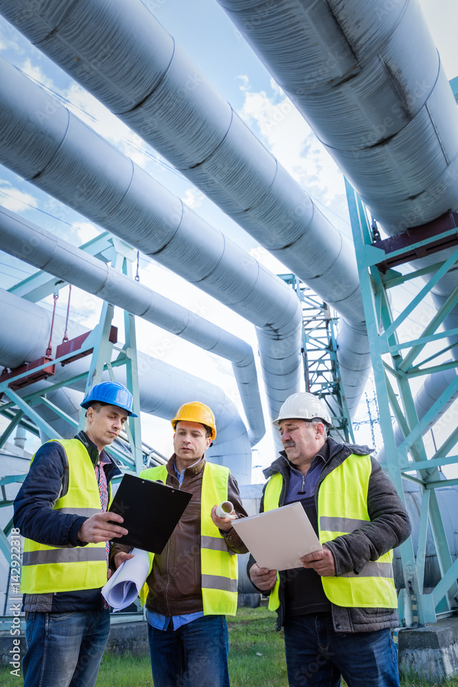 Engineers discussing maintenance of a petrochemical plant