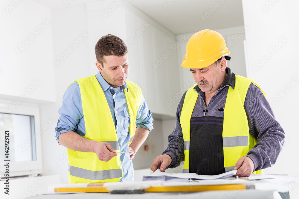 Architect and construction engineer indoor meeting. Architect and construction engineer indoor meeting.