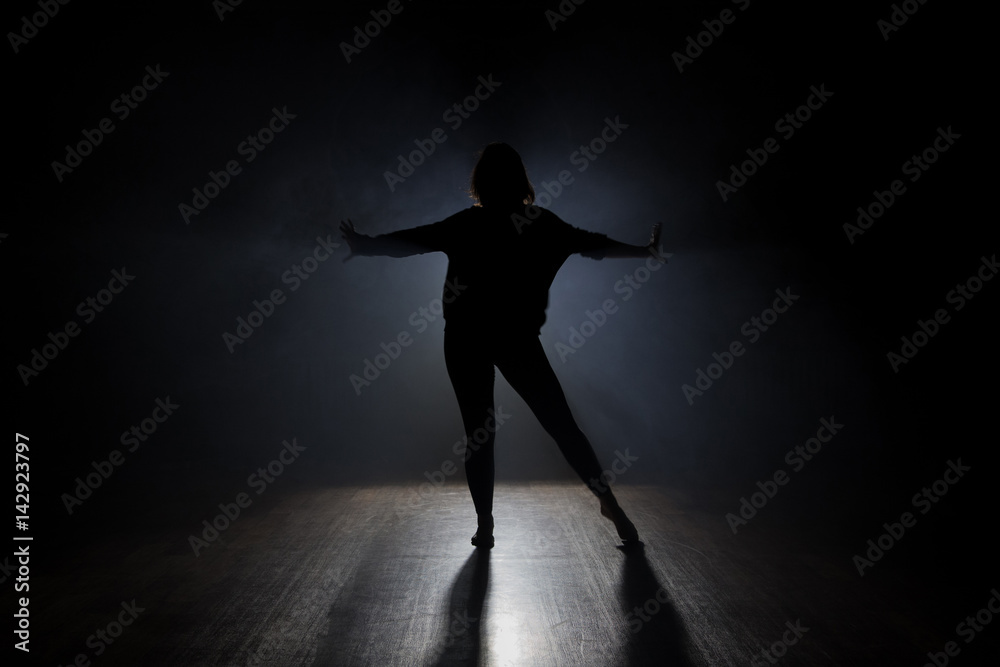 Dancer posing in the dark and smoke