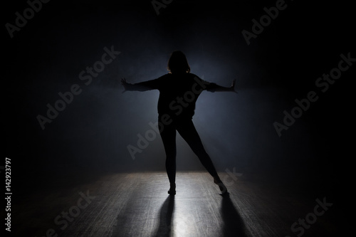 Dancer posing in the dark and smoke © semenenkostas