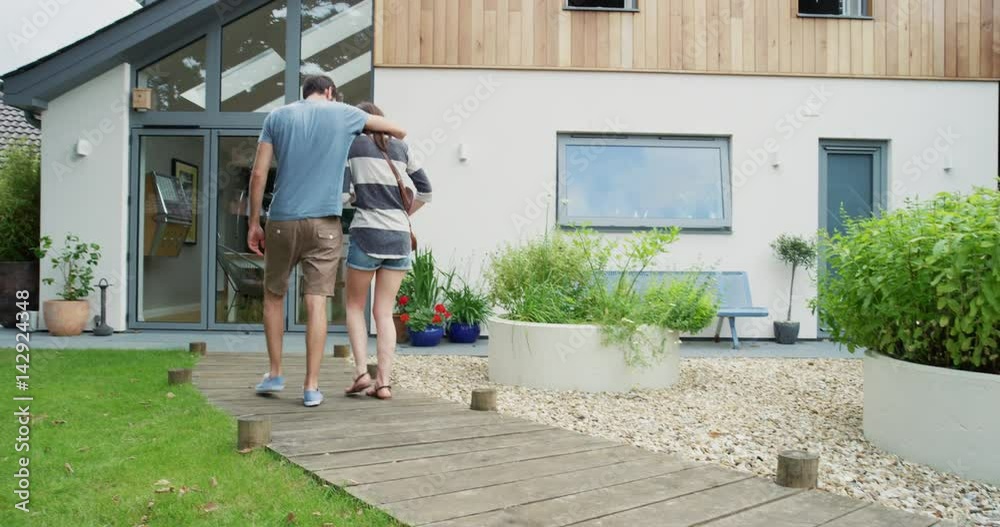 Creative Young Couple arriving at modern new home successful mortgage or weekend away in vacation rental