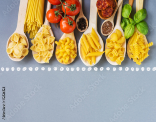 composition of raw pasta Feta cheese, tomatoes, basil and spices. composition recipe of Italian pasta cuisine  photo