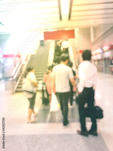 Blurred people on escalators are going to shopping new products and accessories.