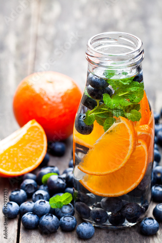 Fototapeta Naklejka Na Ścianę i Meble -  detox  organic blueberry and orange drink on wooden background