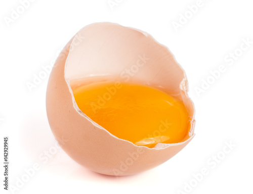 Broken egg with yolk and eggshell isolated on white background