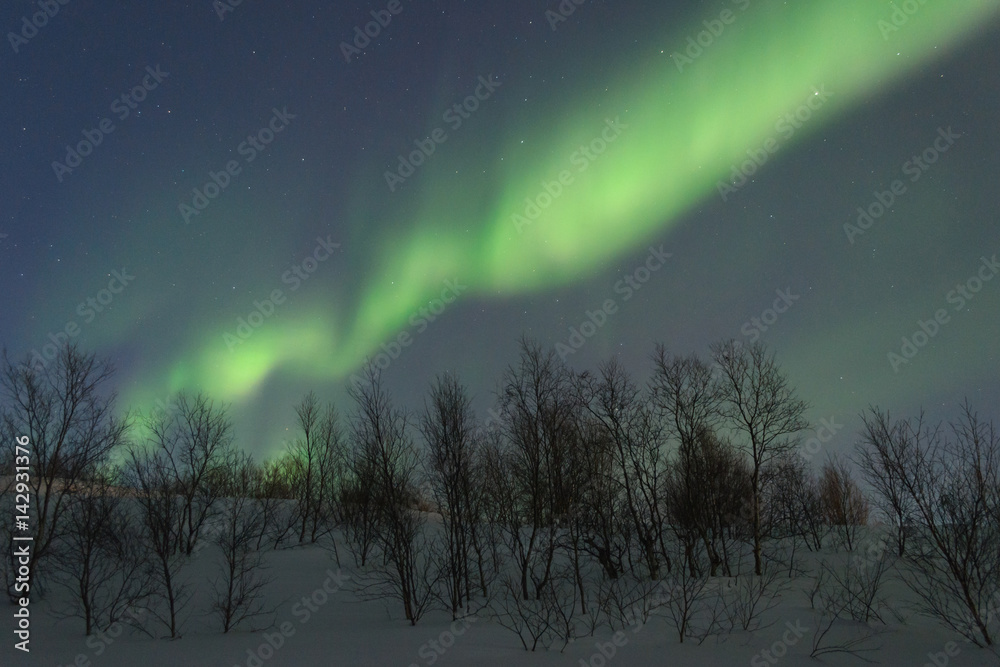 The hills are covered with snow and the Aurora .Night.