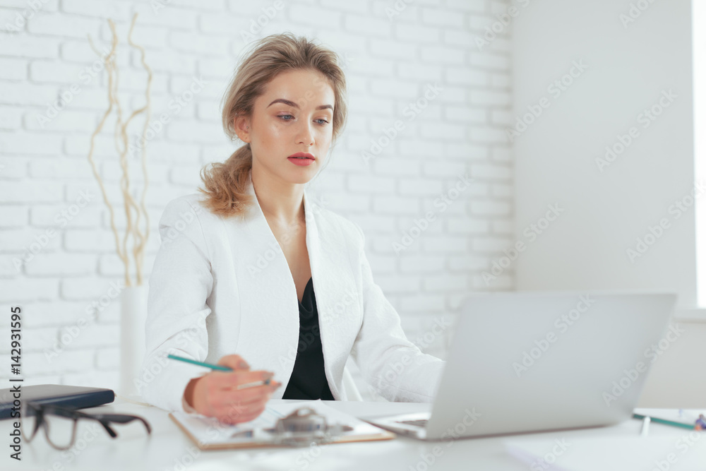 Portrait of beautiful young woman working in the office. Portrait of beautiful young woman working in the office.