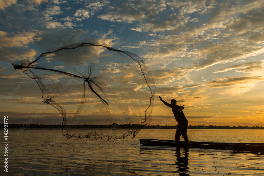 Fisherman is fishing by using fishing net on the river.