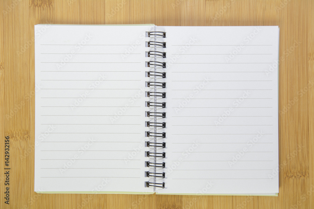 Opening note book on desk Opening note book on desk