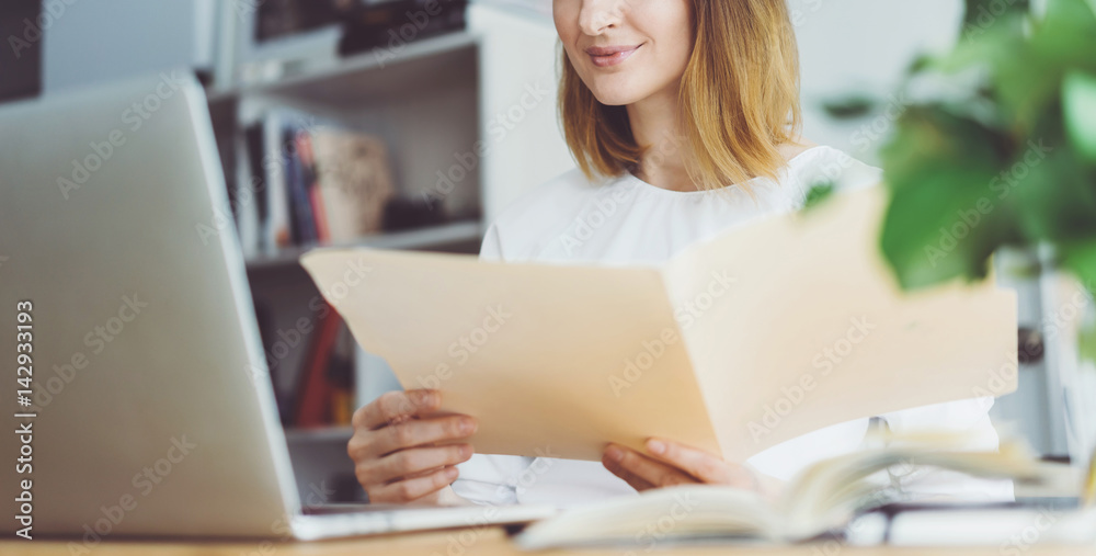 Professional manager working on new financial project, Young business woman in white shirt looking documents with the accounting report of the finance Professional manager working on new financial project, Young business woman in white shirt looking documents with the accounting report of the finance