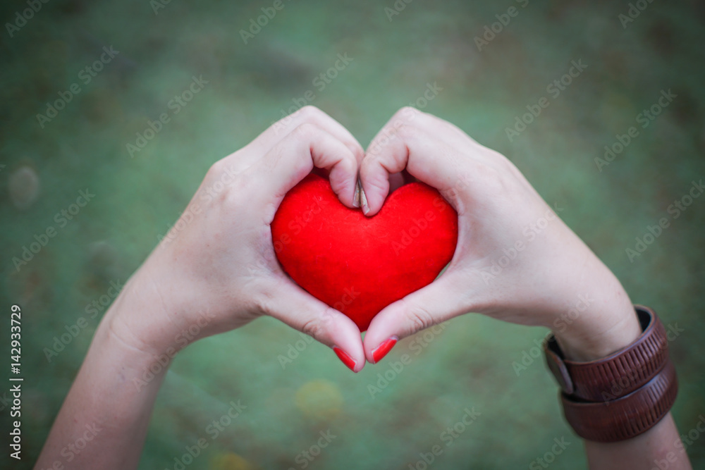 red heart in human hand with dramatic tone red heart in human hand with dramatic tone