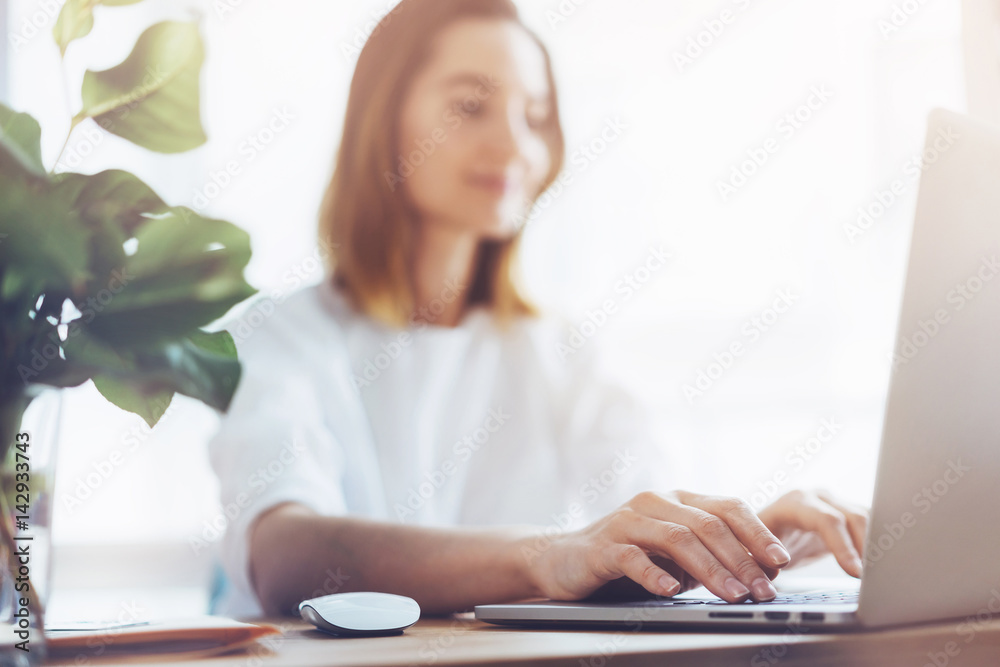 Charming female sitting at office desk with laptop, Young attractive business woman working on new project and using laptop Charming female sitting at office desk with laptop, Young attractive business woman working on new project and using laptop