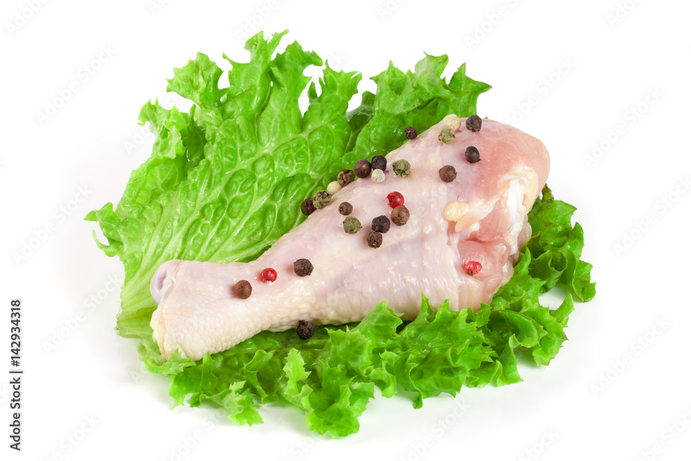 one raw chicken drumstick with lettuce leaf isolated on white background one raw chicken drumstick with lettuce leaf isolated on white background