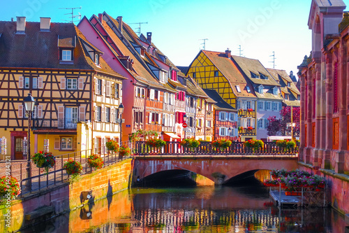 Fototapeta Naklejka Na Ścianę i Meble -  Beautiful late summer afternoon view of traditional colorful half-timbered buildings in the historical old town of Colmar, Alsace wine region in France
