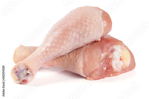 Two raw chicken drumsticks isolated on white background