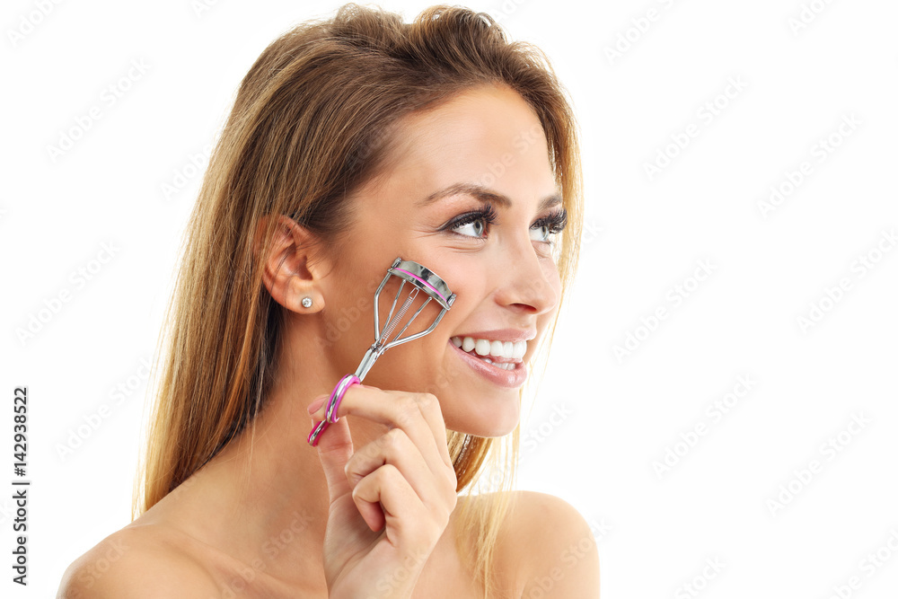 Picture showing woman using eyelash curler over white Picture showing woman using eyelash curler over white