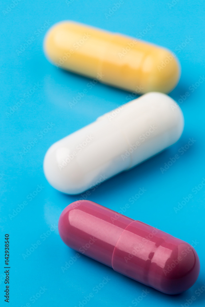 Three multi colored pills Three multi colored pills