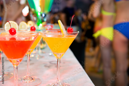 Group of colorful cocktail in martini glasses.