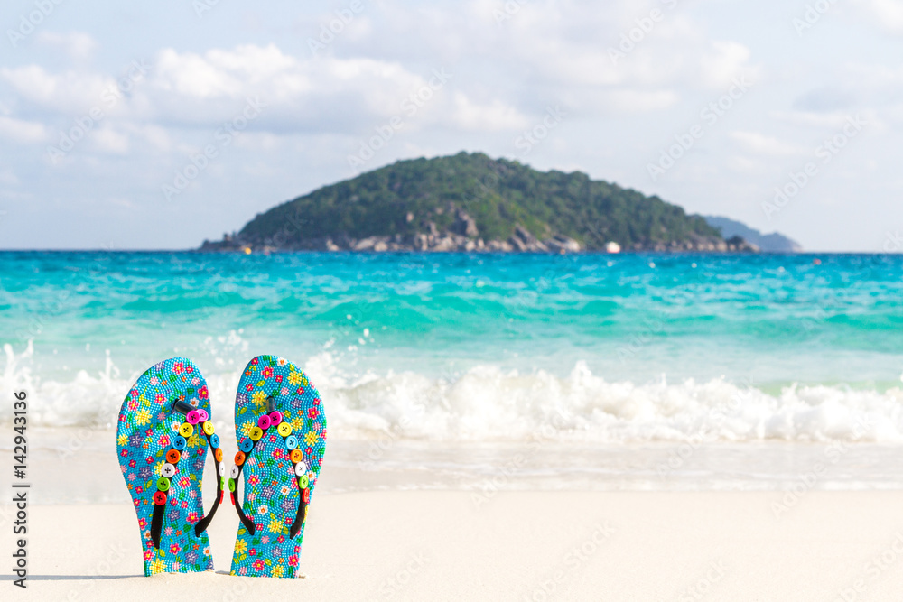 Blue women's beach shoes, with white sand, blue sea and sky. Thailand, Similan Islands. Blue women's beach shoes, with white sand, blue sea and sky. Thailand, Similan Islands.