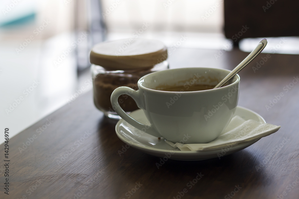 Fresh coffee in white cup on wooden table Fresh coffee in white cup on wooden table