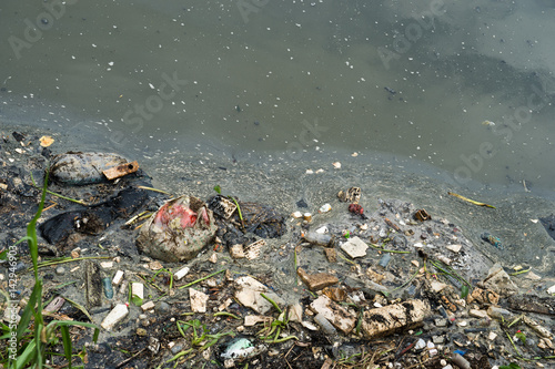 Принти на полотні Water pollution in river with trash.