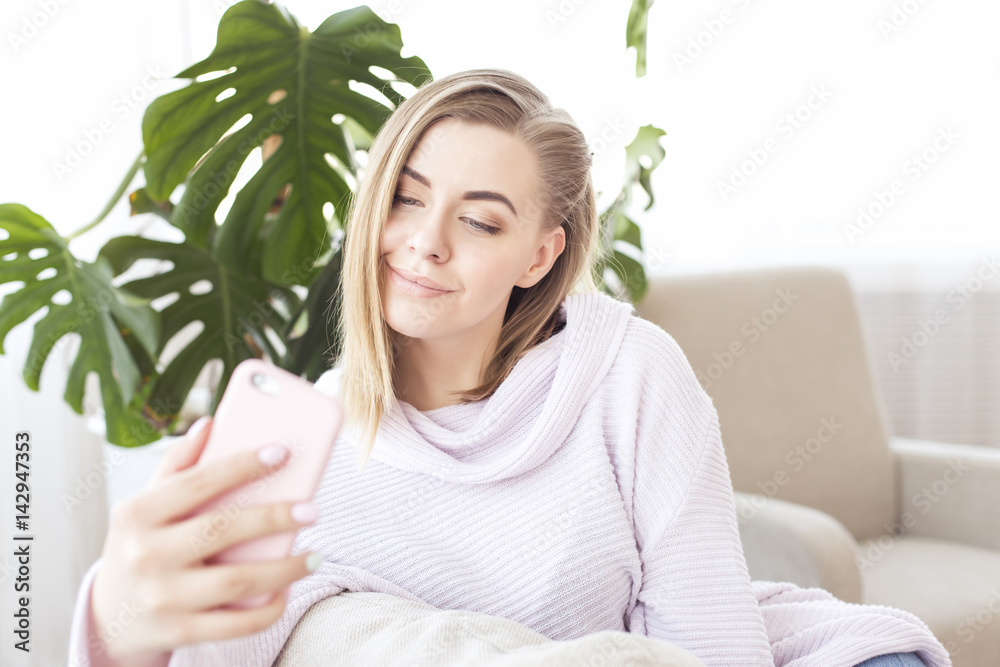 Picture of happy woman with smartphone on sofa Picture of happy woman with smartphone on sofa
