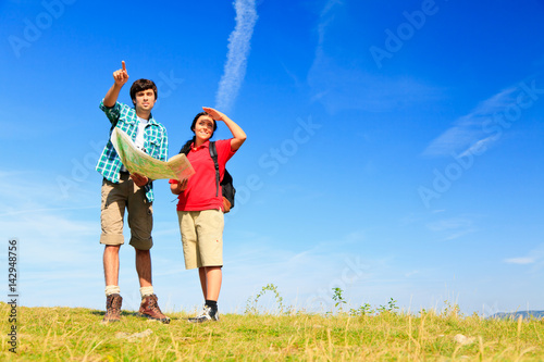 Young Couple Standing At The Top Of A Hill