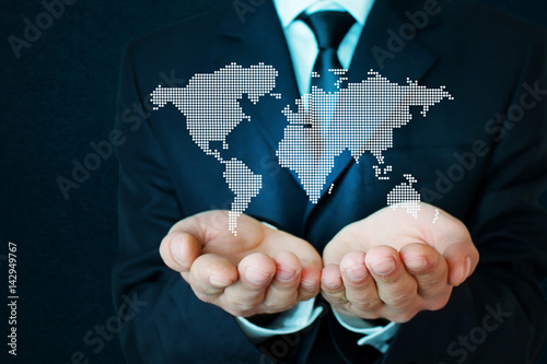 Businessman holding world map.