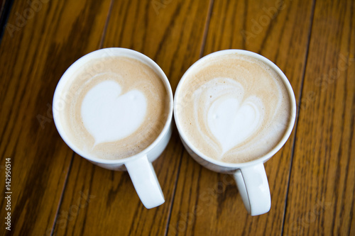 two cups of coffee cappuccino with heart shape
