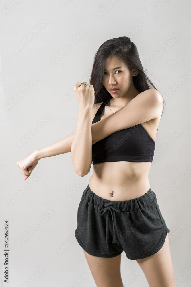 portrait of fit sexy girl wearing sportswear fitness clothing warm for exercise on gray background portrait of fit sexy girl wearing sportswear fitness clothing warm for exercise on gray background