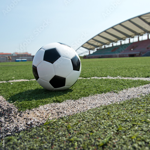 soccer ball on stadium grass line. © xy