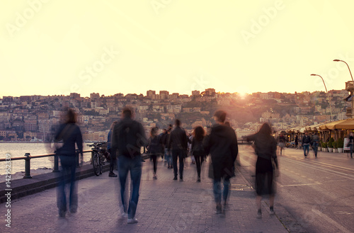 Embankment with groups of people in the evening in Napoli, Italy