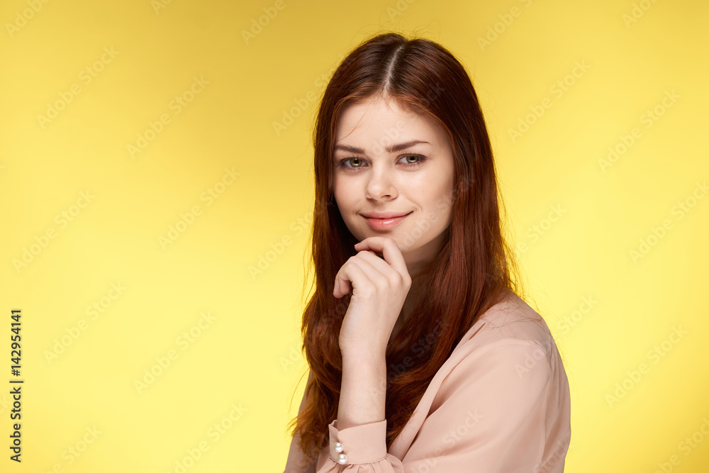 attractive red-haired woman on a yellow background attractive red-haired woman on a yellow background