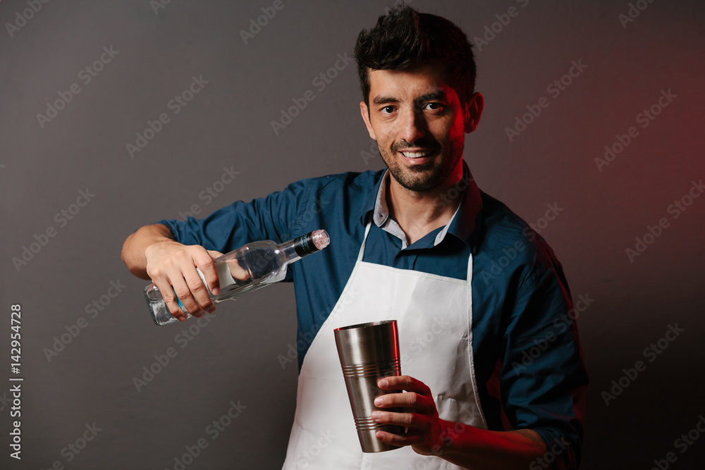Barman makes cocktails with a shaker Barman makes cocktails with a shaker