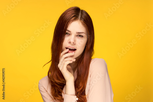 yellow background, attractive woman in a light shirt