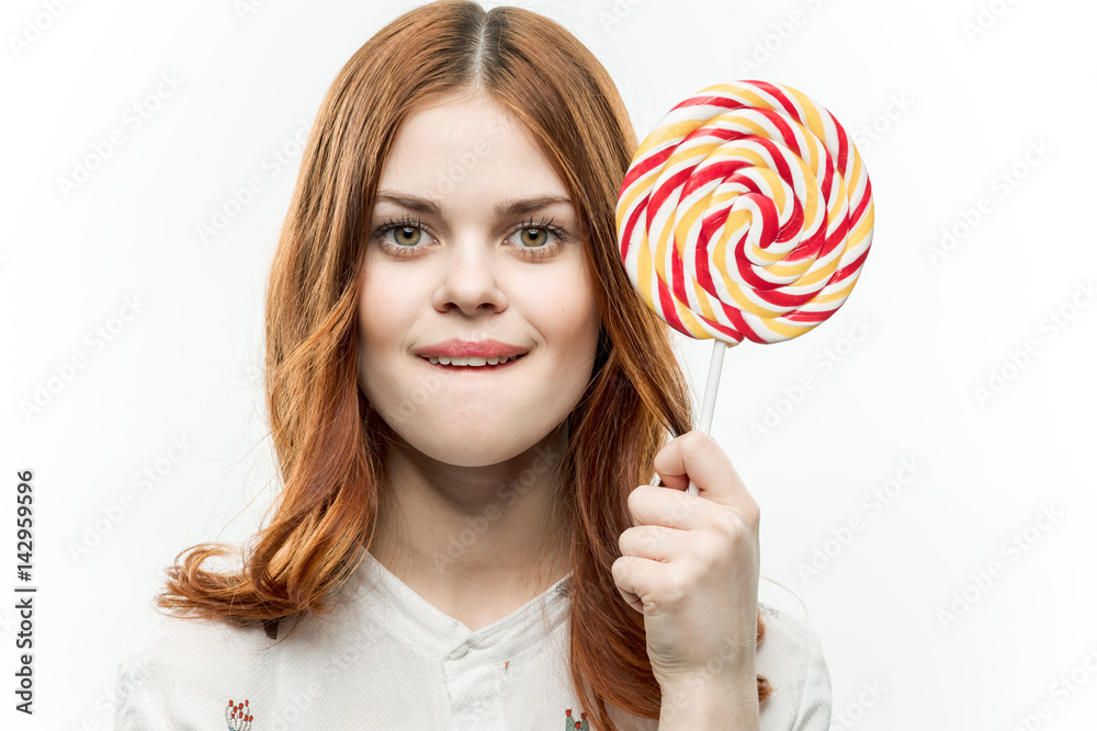 happy woman with round lollipop bite her lip