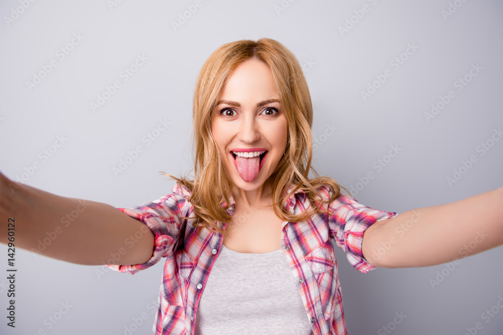 Photography Self portrait of cute funny woman in checkered shirt showing her tongue