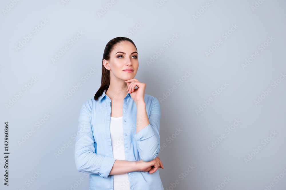 Portrait of attractive minded happy woman dreaming about smth isolated gray background Portrait of attractive minded happy woman dreaming about smth isolated gray background