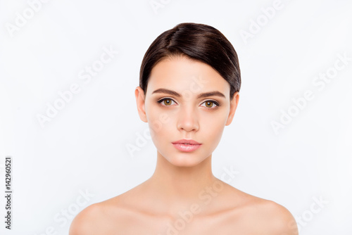 Portrait of calm young beautiful woman showing ideal face