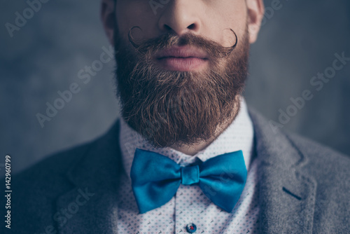 Fotografie Close up cropped photo portrait of stylish hipster brutal young man with red mus