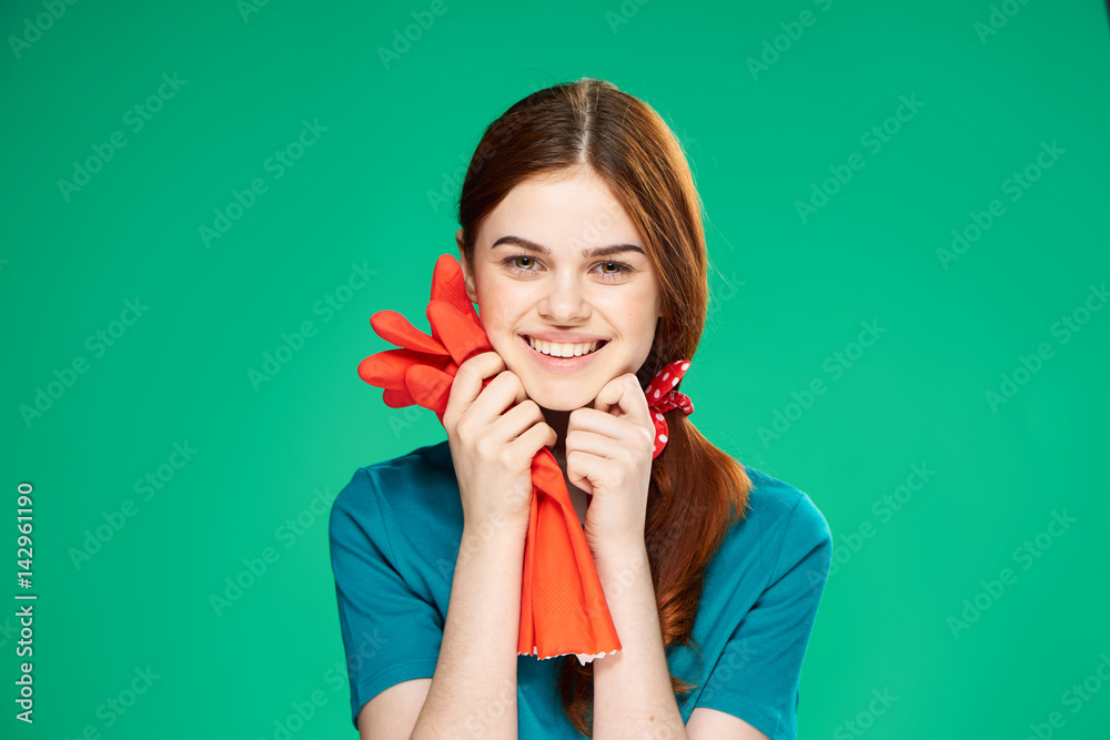 happy woman holding red gloves, blue shirt happy woman holding red gloves, blue shirt